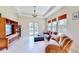 Cozy living room with a tray ceiling, comfortable sofas, and natural light, creating a relaxing space at 5709 Sea Turtle Pl, Apollo Beach, FL 33572