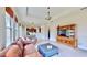 Spacious living room with tile floors, large windows, and open floor plan, perfect for modern living and entertaining at 5709 Sea Turtle Pl, Apollo Beach, FL 33572