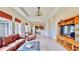 Comfortable living room featuring tile floors, tray ceiling, and an open layout to the kitchen, great for Gathering gatherings at 5709 Sea Turtle Pl, Apollo Beach, FL 33572