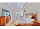 Comfortable main bedroom with a decorative bedframe, plush bedding, and bright windows at 5709 Sea Turtle Pl, Apollo Beach, FL 33572