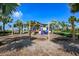 Community playground featuring swings, slides, and climbing structures under a shaded canopy at 5709 Sea Turtle Pl, Apollo Beach, FL 33572