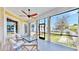 Relaxing screened-in porch with comfortable seating, ceiling fan, and views of the manicured backyard at 5709 Sea Turtle Pl, Apollo Beach, FL 33572