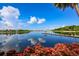 Picturesque waterfront view with a dock, gazebo, and lush foliage reflecting on the serene water at 5709 Sea Turtle Pl, Apollo Beach, FL 33572