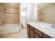 Bright bathroom featuring double sinks, tile floors, and a tub with shower at 5710 Kingletsound Pl, Lithia, FL 33547