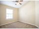 Cozy bedroom with neutral carpet, light walls, and a ceiling fan at 5710 Kingletsound Pl, Lithia, FL 33547