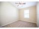 Cozy bedroom with neutral carpet, light walls, and a ceiling fan at 5710 Kingletsound Pl, Lithia, FL 33547
