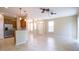 A living room with an open layout connected to the kitchen that offers barstool seating and plenty of natural light at 5710 Kingletsound Pl, Lithia, FL 33547