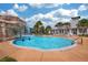 Resort-style pool with a rock waterfall feature and plenty of lounge chairs at 5710 Kingletsound Pl, Lithia, FL 33547