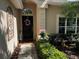 Inviting front entrance with decorative wreath, sidelight, and well-maintained landscaping at 5912 Tulip Flower Dr, Riverview, FL 33578