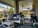 Cozy screened-in porch with wicker furniture, potted plants, and a tranquil view, perfect for relaxation at 5912 Tulip Flower Dr, Riverview, FL 33578