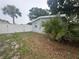 Fenced backyard featuring a white vinyl fence and mature palm trees at 6690 33Rd N Ave, St Petersburg, FL 33710