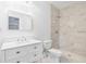 Renovated bathroom features a walk-in shower with decorative tiled walls and a vanity at 6690 33Rd N Ave, St Petersburg, FL 33710