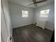 Bright bedroom with hardwood floors, two windows, and a dresser at 6690 33Rd N Ave, St Petersburg, FL 33710