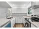 Well-lit kitchen offers stainless appliances, granite counters, and bright white cabinetry at 6690 33Rd N Ave, St Petersburg, FL 33710