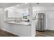 Bright kitchen featuring stainless steel refrigerator, granite countertops and white cabinets at 6690 33Rd N Ave, St Petersburg, FL 33710