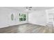 Spacious living room with modern flooring, neutral paint, bright windows, and a ceiling fan at 6690 33Rd N Ave, St Petersburg, FL 33710