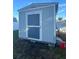 A compact shed in the backyard with a neutral color scheme and secure door at 6690 33Rd N Ave, St Petersburg, FL 33710