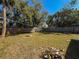 Spacious backyard with a privacy fence and mature trees at 6708 S Faul St, Tampa, FL 33616
