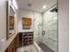 Modern bathroom with a glass-enclosed shower, stylish marble tiling, and unfinished wall, providing a luxurious feel at 6708 S Faul St, Tampa, FL 33616