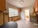 Spacious kitchen with tile flooring, wood cabinets, and a bright window at 6708 S Faul St, Tampa, FL 33616