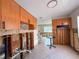 Open kitchen with tiled backsplash, wood cabinets, and tile flooring at 6708 S Faul St, Tampa, FL 33616