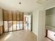 Living room featuring tile flooring, exposed framing and door to the bathroom, with a view to the kitchen at 6708 S Faul St, Tampa, FL 33616