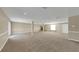 Large basement area features neutral carpeting, a stone fireplace, and ample space for various uses at 6901 298Th N Ave, Clearwater, FL 33761