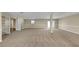 Expansive finished basement with neutral carpet, recessed lighting, and multiple entry points for convenience at 6901 298Th N Ave, Clearwater, FL 33761