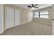 Bedroom with ceiling fan, two large closets, and natural lighting at 6901 298Th N Ave, Clearwater, FL 33761