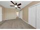 Bedroom with ceiling fan and multiple closets at 6901 298Th N Ave, Clearwater, FL 33761