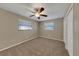 Cozy bedroom featuring two bright windows and ceiling fan at 6901 298Th N Ave, Clearwater, FL 33761