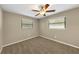 Bright bedroom featuring two bright windows and neutral carpet at 6901 298Th N Ave, Clearwater, FL 33761