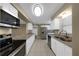 Bright and modern kitchen featuring stainless steel appliances, granite countertops, and white cabinetry at 6901 298Th N Ave, Clearwater, FL 33761