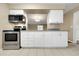 Well-appointed kitchen with granite counters, white cabinets, and modern appliances creating a great space at 6901 298Th N Ave, Clearwater, FL 33761