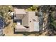 Aerial view of the house showing the roof, screened patio, driveway, and surrounding landscape at 7208 Baltusrol Dr, New Port Richey, FL 34654