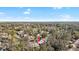 Aerial neighborhood shot of a single-story home with driveway and mature trees at 7208 Baltusrol Dr, New Port Richey, FL 34654