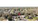 An aerial view of a home nestled within a lush, green, wooded neighborhood at 7208 Baltusrol Dr, New Port Richey, FL 34654