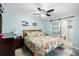 Bright bedroom with a queen bed, barn door leading to the bathroom, and stylish decor at 7208 Baltusrol Dr, New Port Richey, FL 34654