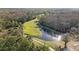 A scenic golf course with lush green grass and mature trees, along with a pond at 7208 Baltusrol Dr, New Port Richey, FL 34654