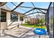 Spacious screened patio with brick pavers plus a small yard area for outdoor enjoyment at 7208 Baltusrol Dr, New Port Richey, FL 34654