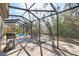 Large screened patio with a grill, brick pavers, and a kiddie pool, ideal for entertainment at 7208 Baltusrol Dr, New Port Richey, FL 34654