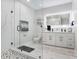 Modern bathroom featuring a glass shower, dual vanity with illuminated mirror, and marble accents at 7403 Edgemere Rd, Tampa, FL 33625