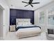 Stylish bedroom featuring a modern accent wall, a comfortable bed, and soft, natural lighting at 7403 Edgemere Rd, Tampa, FL 33625