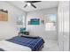 Comfortable bedroom featuring cozy bedding, two windows with natural light and a ceiling fan at 7403 Edgemere Rd, Tampa, FL 33625
