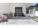 Inviting front porch with tiled flooring, stylish seating, and a modern front door with glass panels at 7403 Edgemere Rd, Tampa, FL 33625