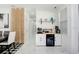 Bright hallway with a beverage station with a mini fridge, adding convenience and style to the space at 7403 Edgemere Rd, Tampa, FL 33625