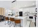 Modern kitchen with marble countertops, and a central island with seating, perfect for casual dining at 7403 Edgemere Rd, Tampa, FL 33625