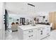 Bright, open-concept kitchen with marble countertops and modern lighting fixtures at 7403 Edgemere Rd, Tampa, FL 33625