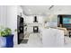 Contemporary kitchen with white cabinetry, marble countertops, stainless steel appliances, and marble floors at 7403 Edgemere Rd, Tampa, FL 33625