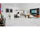 Bright open-concept living room with sleek marble floors and ample natural light at 7403 Edgemere Rd, Tampa, FL 33625